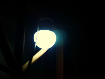 Low angle view of illuminated lamp at night