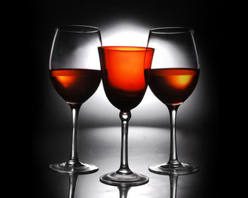 Close-up of wineglass against black background