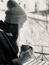 Close-up of woman drinking coffee outdoors during winter