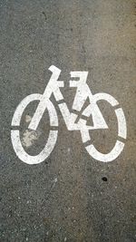 Directly above shot of bicycle sign on road