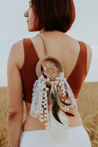  midsection of woman with boho dream catcher