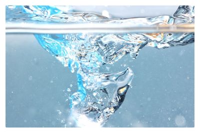 Close-up of splashing water in glass