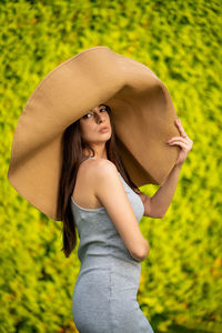 Young beautiful woman with big summer hat