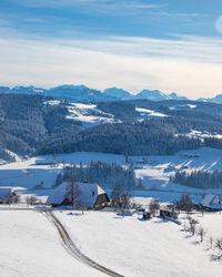 Scenic view of snow covered mountains against sky