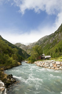 Scenic view of waterfall against sky