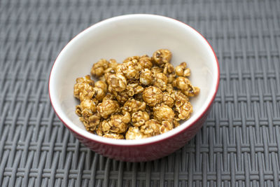 Close-up of caramel corn in bowl on table