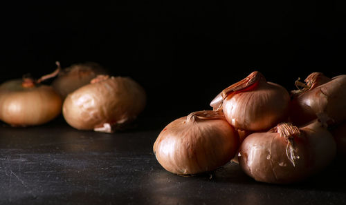 Close-up of pumpkins on table against black background