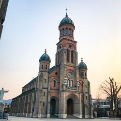 Low angle view of clock tower against sky