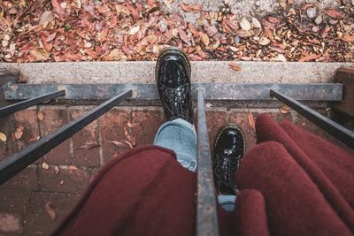 Low section of man standing on footpath