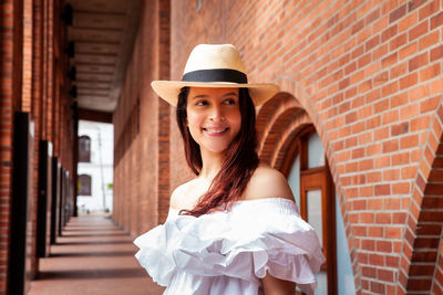 Beautiful young woman wearing a traditional hat from aguadas in colombia called an aguadeño hat.