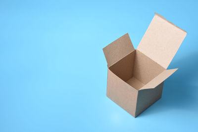 Close-up of cardboard box against blue background