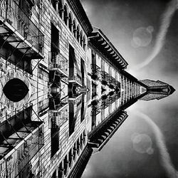 Low angle view of building against cloudy sky