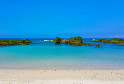 View of beach against blue sky