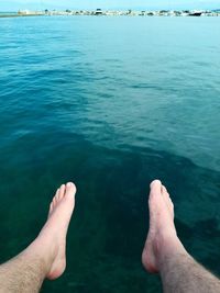 Low section of people relaxing in sea