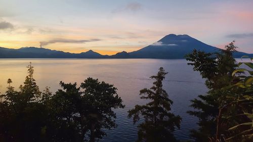 Scenic view of sea and mountains against sky