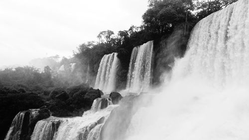 Scenic view of waterfall against clear sky