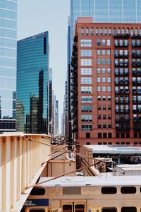 Train by buildings in city