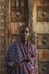 Masai men standing in front of a traditional door in old town