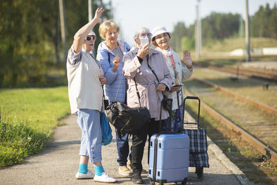 Rear view of people walking on road