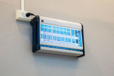 Low angle view of telephone booth on wall