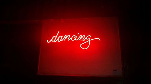 Neon lighting word dancing in red