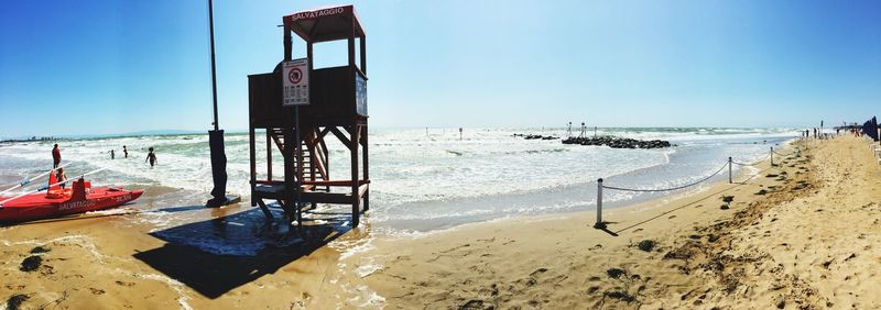 Scenic view of beach against blue sky