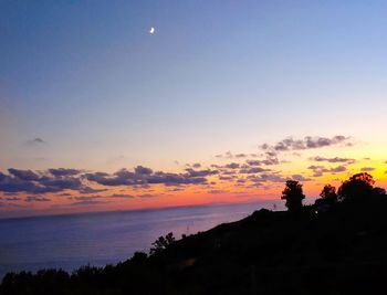 Scenic view of silhouette landscape against sky at sunset