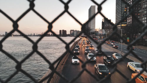 Cityscape seen through chainlink fence