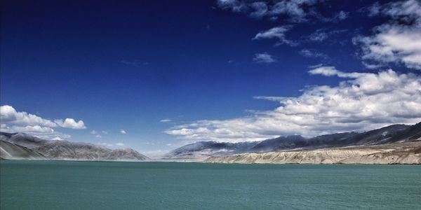 Scenic view of mountains against blue sky