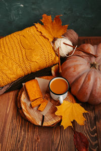 High angle view of orange and leaves on table