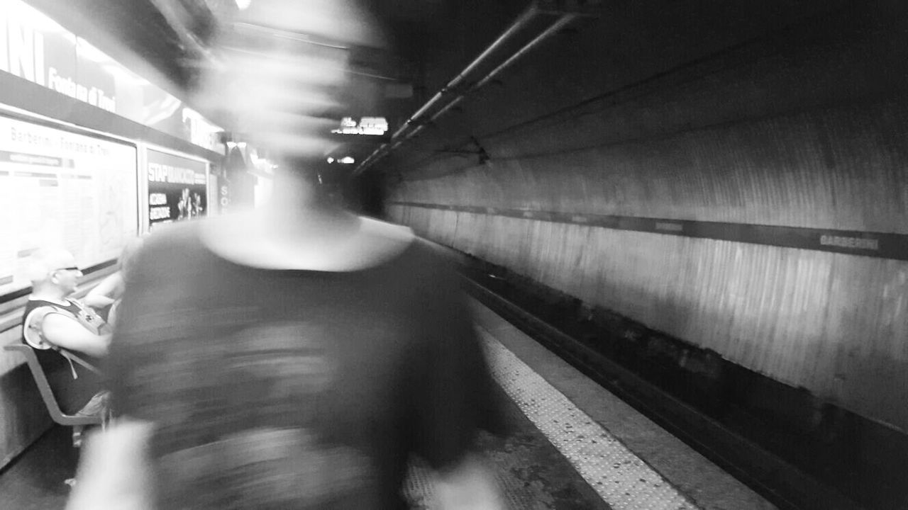 TRAIN PASSING THROUGH RAILROAD STATION PLATFORM