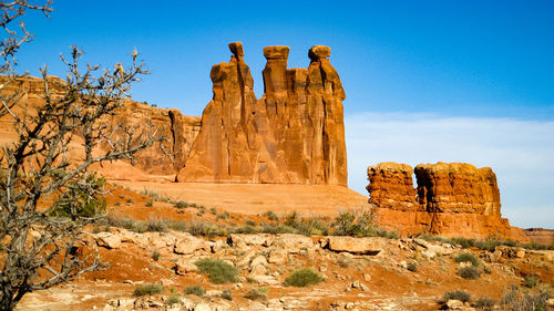 Low angle view of rock formation against clear blue sky