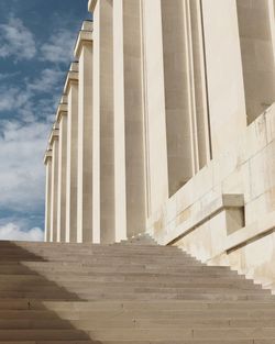 Low angle view of colonnade against sky