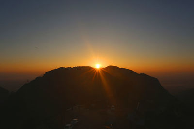 Scenic view of silhouette mountains against sky during sunset