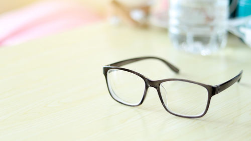 Close-up of eyeglasses on glass table