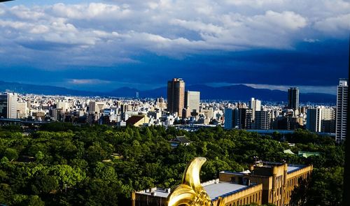 Cityscape against cloudy sky