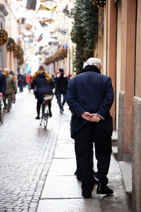 Rear view of man walking on street