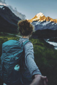 Rear view of man with umbrella on mountain