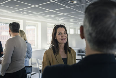 Business people talking during conference break