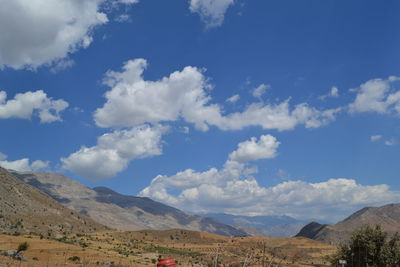 Scenic view of mountains against cloudy sky