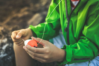 Midsection of man holding spinning top