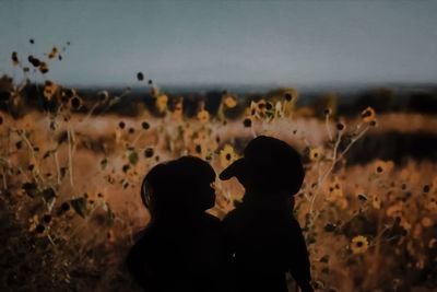 Silhouette people against sky during rainy season