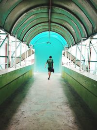 Full length rear view of man walking