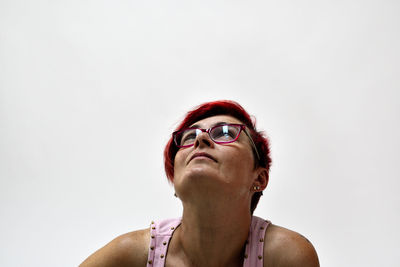 Portrait of man looking away against white background