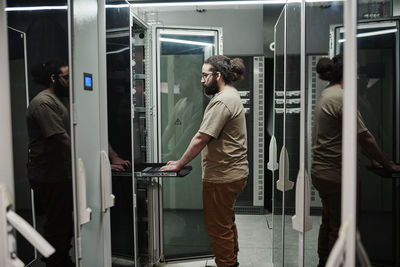 Computer technician working in server room