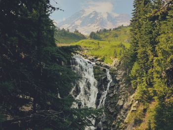 Scenic view of waterfall against sky