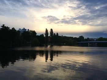 Scenic view of river against sky at dusk