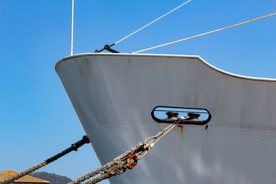 Low angle view of ship against clear blue sky