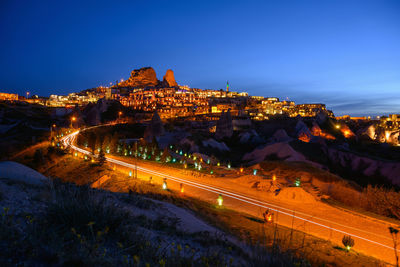 Illuminated city against sky at night