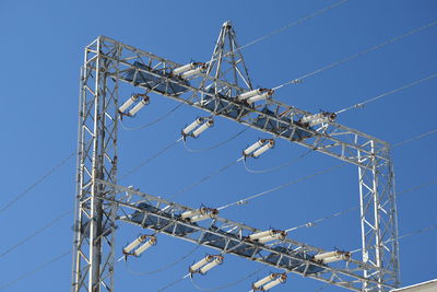 Low angle view of ferris wheel against clear blue sky